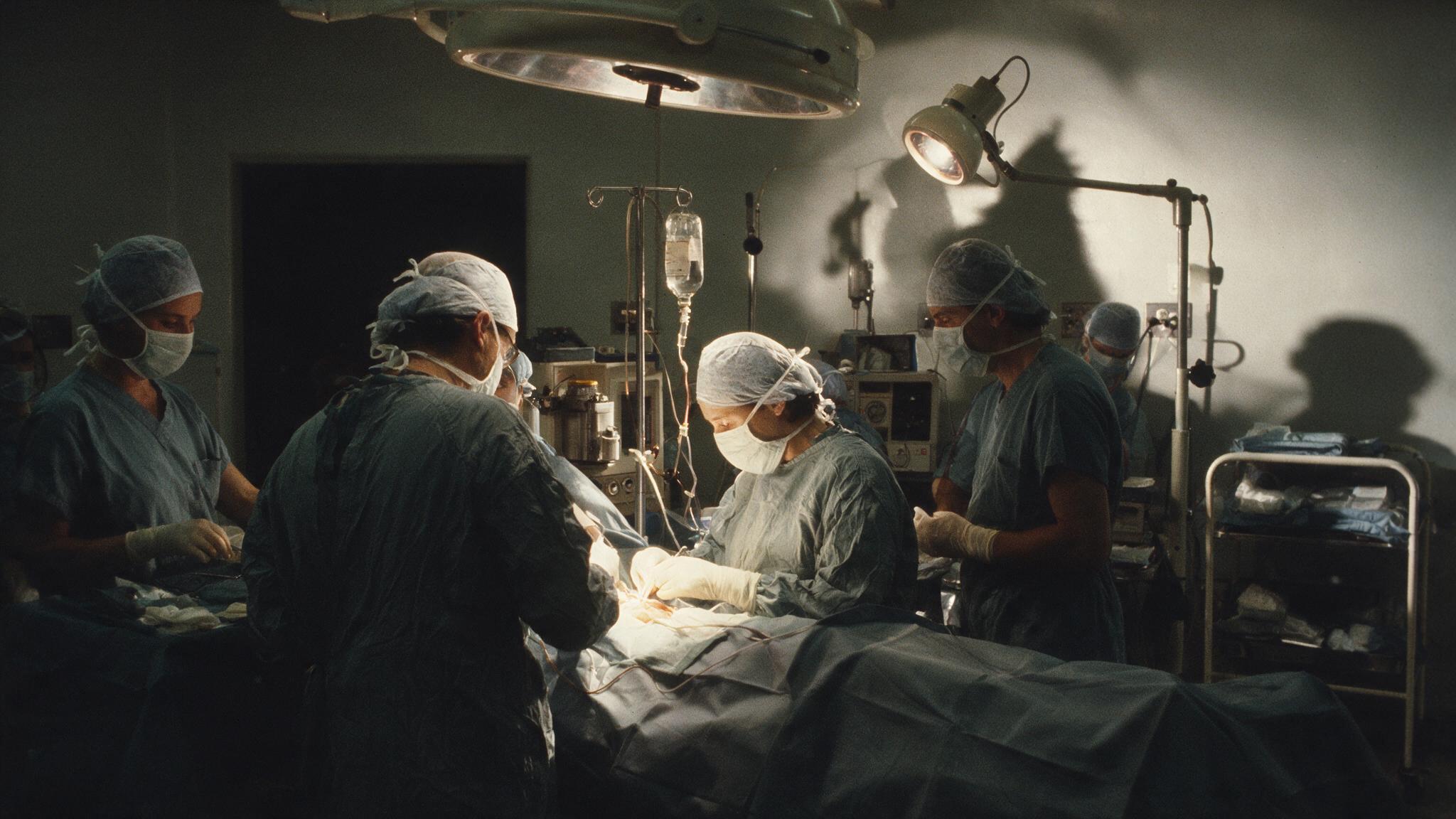 Illustration of a surgical team in an operating theatre.